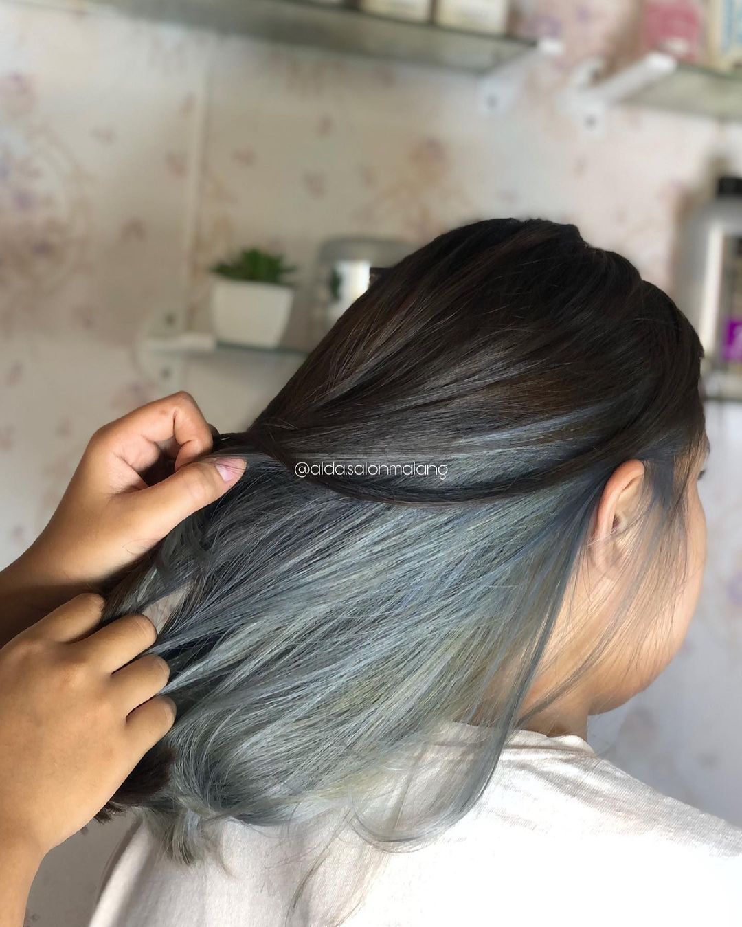 Dark blue peekaboo highlights under black hair